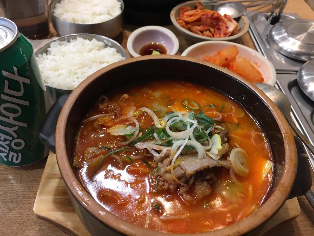 A bubbling Korean stew with rice and banchan on the side at Sendai